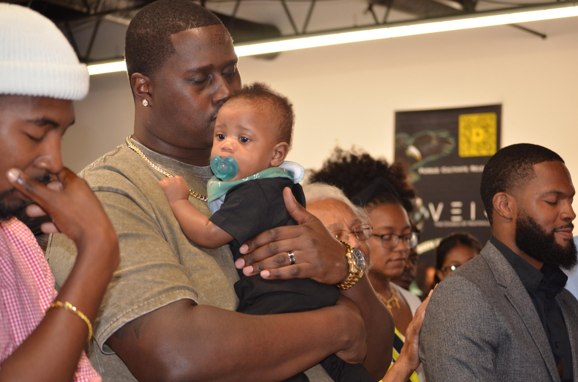 A father holding his baby during a service